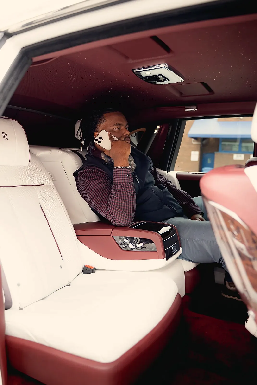 Negus on a call in the back of a Rolls-Royce.